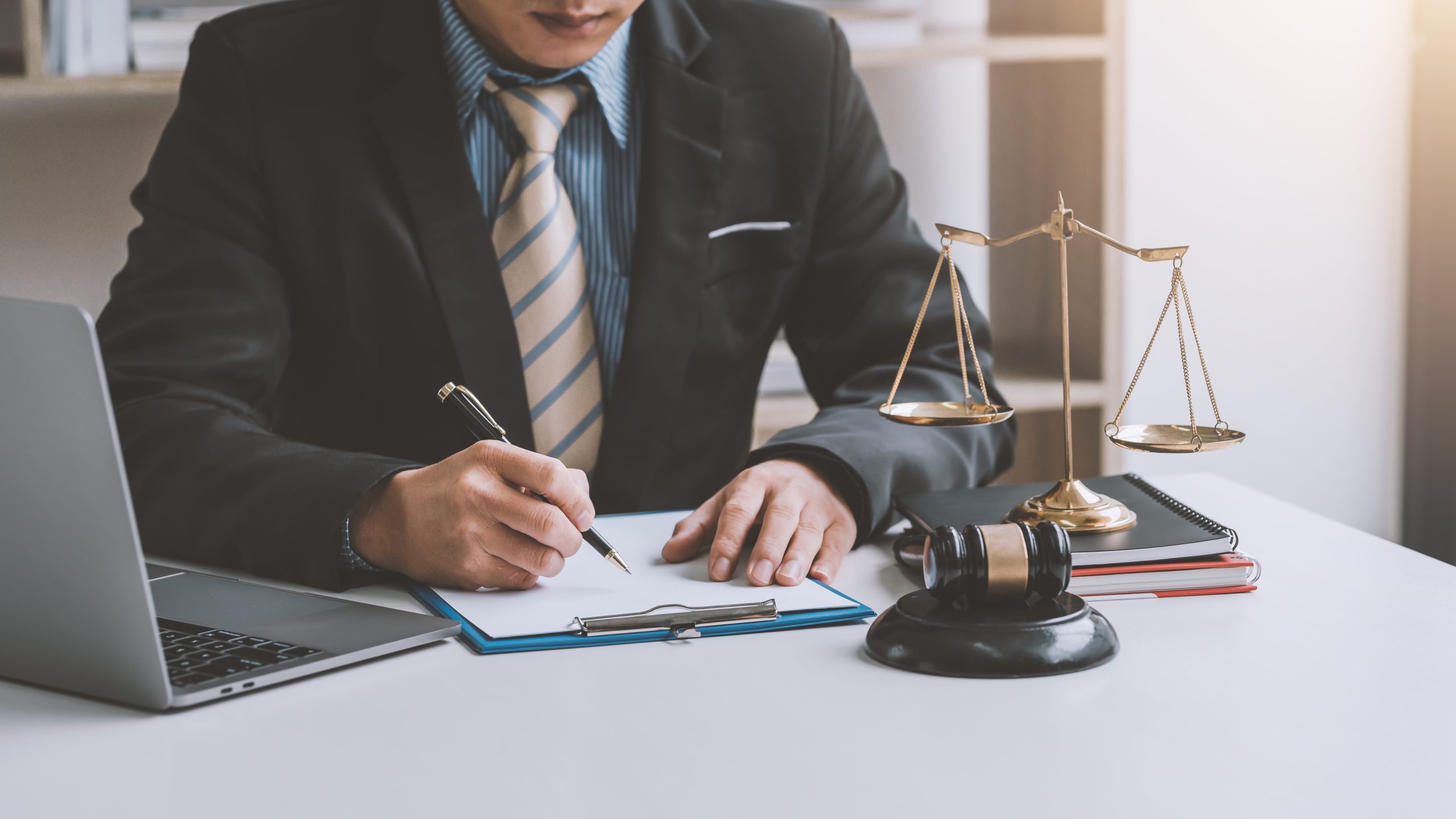 Close-up of businessman and lawyer hand holding pen to taking notes at office.